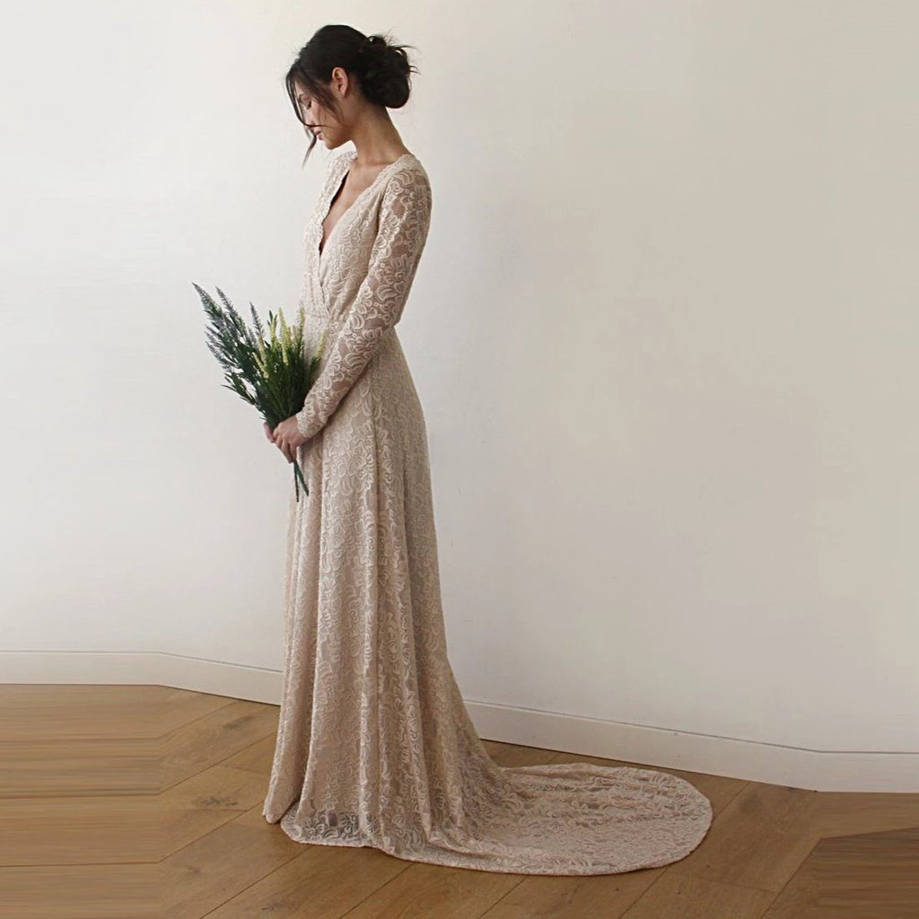 Side profile - champagne wrap lace wedding gown with train and long sleeves - Douceur de Vivre Paris.