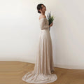 Right side view of model wearing a champagne off-shoulder lace wedding gown with long sleeves, fitted silhouette, and trailing train.